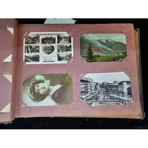 142 - A wonderful antique post card album containing Italian, British and Irish examples. Approx 70% full.