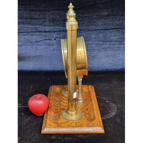 217 - A gorgeous and rare mid century brass table clock featuring two columns with finials to top sat on a... 