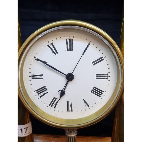 217 - A gorgeous and rare mid century brass table clock featuring two columns with finials to top sat on a... 