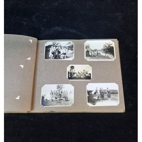 226 - A beautiful early 20th century photo album containing a wonderful selection of miniature scouting th... 