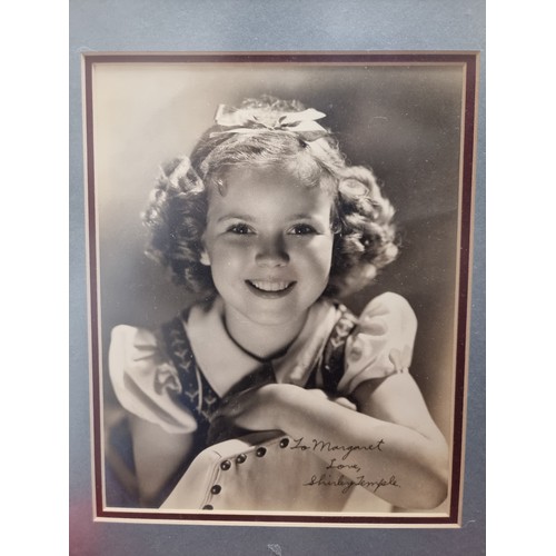 353 - Star lot : A wonderful piece of film memorabilia comprising of a hand sided photo of Shirley Temple ... 