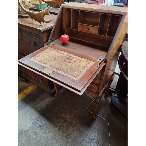 585 - A beautiful early 20th century writing desk with three pull out drawers Bakelite handles and cabriol... 