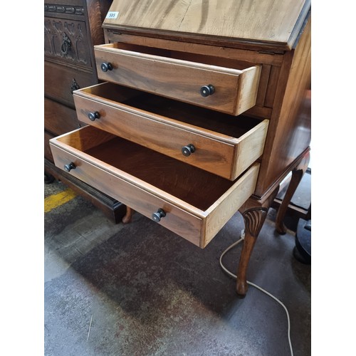 585 - A beautiful early 20th century writing desk with three pull out drawers Bakelite handles and cabriol... 