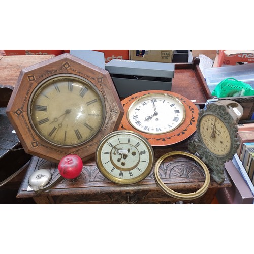 586 - A crate containing a selection of vintage items including three clocks, and a weighing scales.