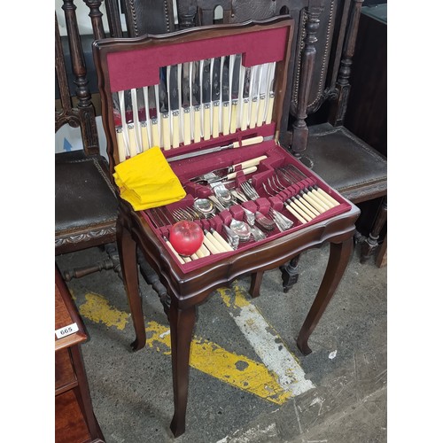 666 - Star Lot : Elegant mahogany side table opening to reveal an as new cutlery canteen. Featuring Queen ... 