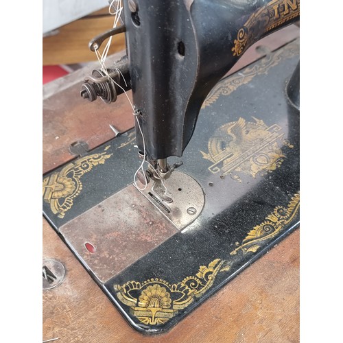 669 - Star Lot : A fab antique singer sewing machine with wooden work table and original foot pedal. Very ... 