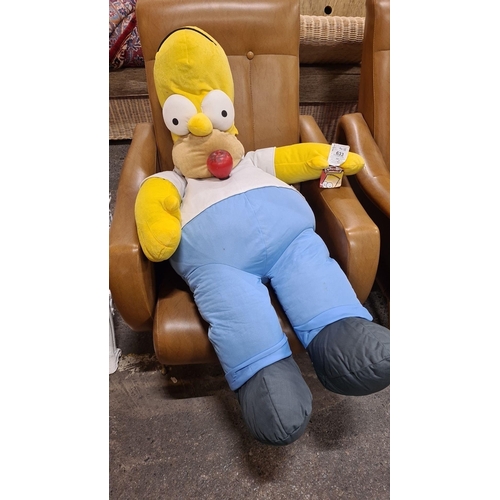 A very large plush doll depicting Homer Simpson from The Simpsons with original tags ideal for c