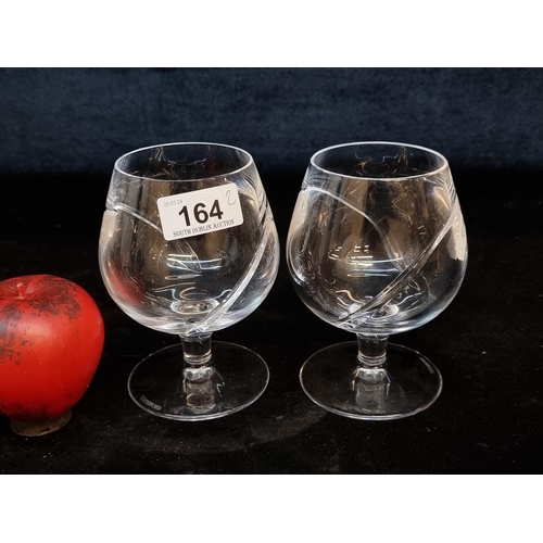 164 - A pair of large Waterford Crystal brandy glasses in a contemporary design. Both in good condition wi... 