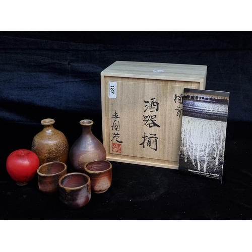 187 - A stunning set of Japanese art studio pottery encased in a wooden crate. Including 3 sake cups and 2... 