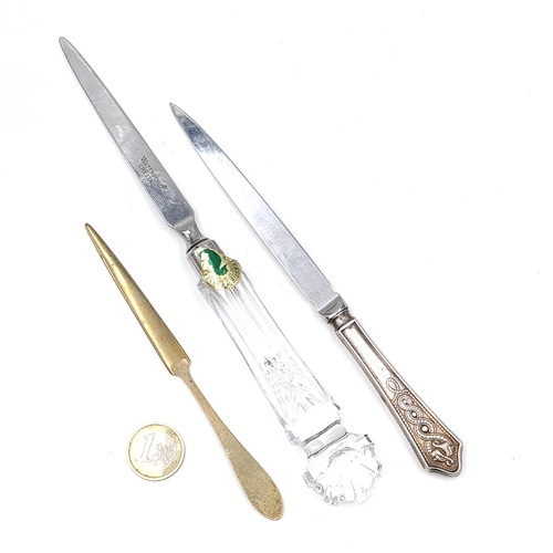 13 - A collection of three letter openers. A Waterford crystal example, Length - 24 cms. A Newbridge silv... 