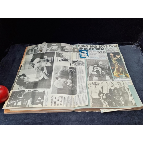 932 - A highly interesting scrapbook containing a large quantity of newspaper clippings of the band U2.