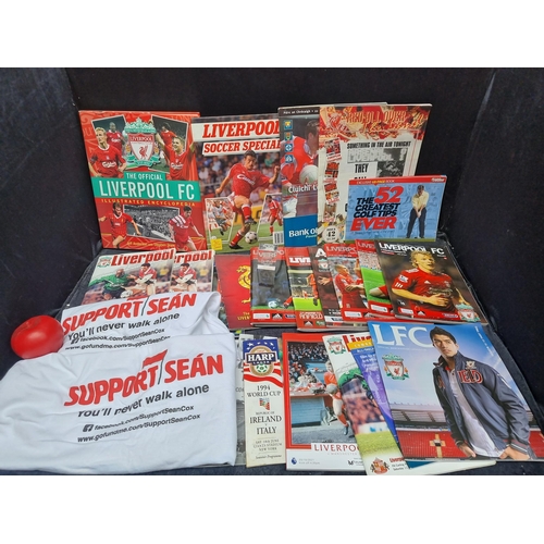 944 - A cool collection of Liverpool FC memorabilia including programmes, annuals, t shirts and paperweigh... 