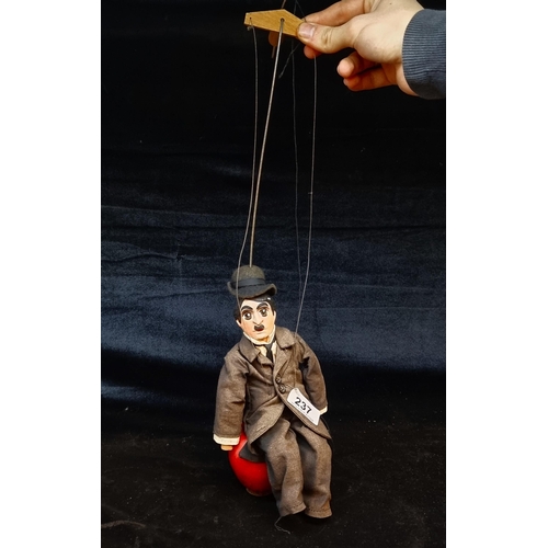 237 - A vintage Charlie Chaplin string puppet, with original clothing and hat. Missing his hands and feet ... 