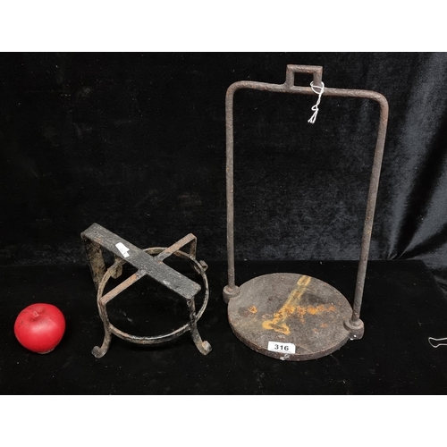 Two antique cast iron items including a railway lamp holder as well as a wall bracket lamp holder.