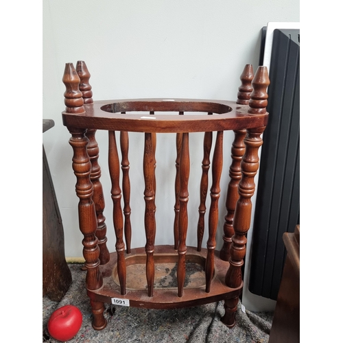 1091 - A handsome Victorian footed umbrella stand with a removable copper base features turned wood spindle... 