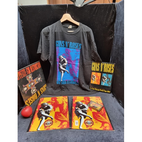 945 - A fabulous lot of Guns and Roses memorabilia including a vinyl album, t shirt, tape and picture book... 