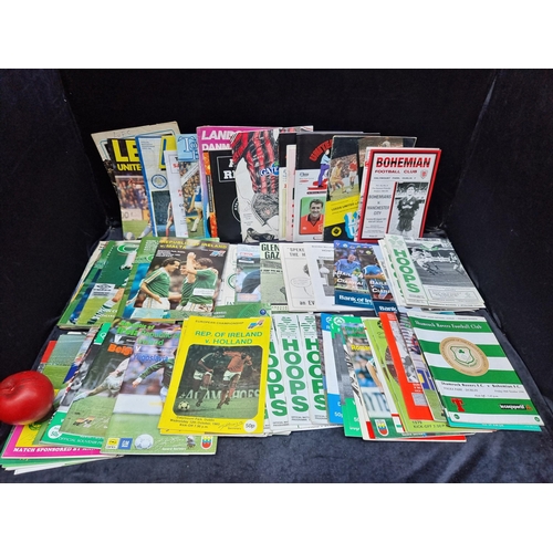 956 - Three bags containing a large and impressive collection of vintage British and Irish football progra... 