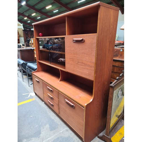 489 - Star Lot :A terrific Mid Century Teak display cabinet / bookcase. Features a fold down home bar spac... 