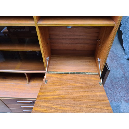 489 - Star Lot :A terrific Mid Century Teak display cabinet / bookcase. Features a fold down home bar spac... 