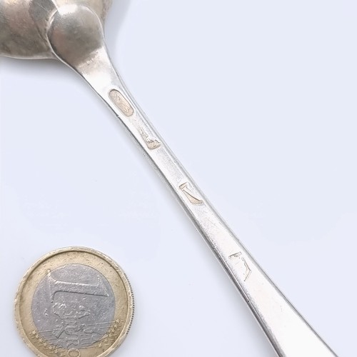 502 - An interesting large silver serving spoon hallmarked London. Dated - 1735. Marks slightly indistinct... 