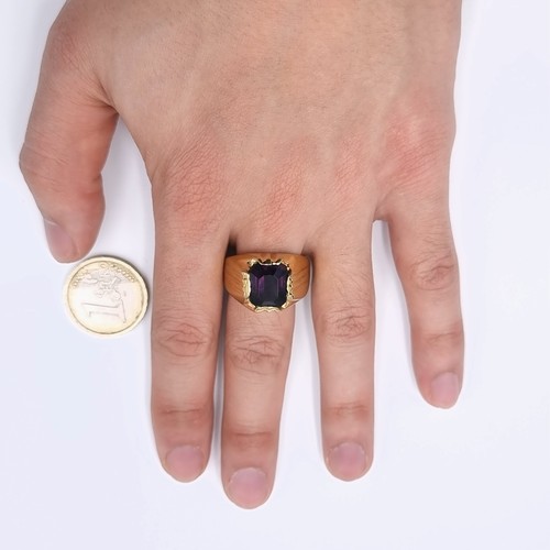 525 - Star Lot : A large heavy amethyst gents stone ring with wide band fitting. Set in an unmarked 9ct go... 