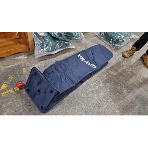A 'Top Flite' golf bag travel cover, navy blue, with padded top for