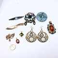 A collection of attractive gemstone pendants together with earrings and ...
