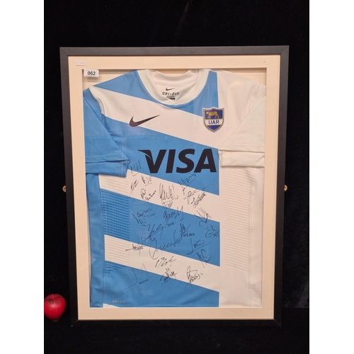 62 - Star Lot : A framed Argentinian Rugby (pumas) Hand Shirt signed by the team. Signed by Hernandez, Ti... 