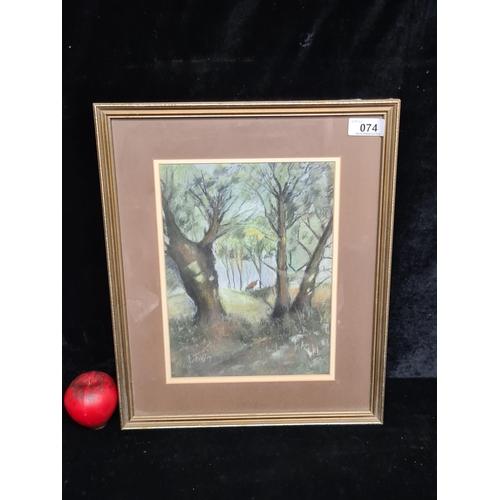 74 - An atmospheric chalk pastel on paper drawing featuring a shadowy woodland landscape. Signed J Timlin... 