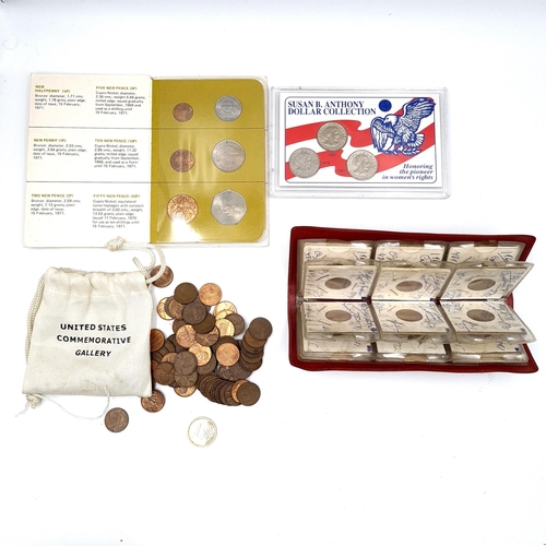 A collection of coinage consisting of a wallet containing 24 international coinage, mostly Canadian mounted with date and inscription. Together with an Irish mint set of Ireland Decimal coins and a mounted, sealed Suzanne B. Anthony dollar collection. Also a bag containing one cent coins at weight 200g.
