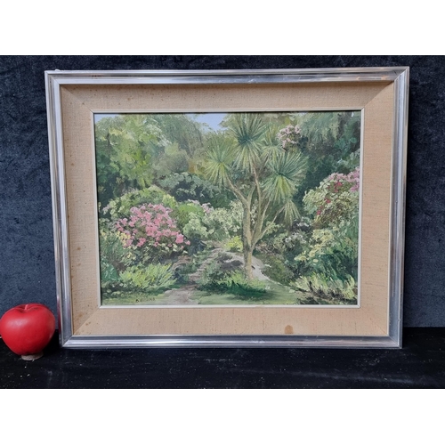 829 - An original 'B. Hilliard' oil on board painting. Features a rich lush greenery with vibrant flowers.... 