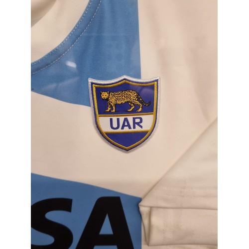 62 - Star Lot : A framed Argentinian Rugby (pumas) Hand Shirt signed by the team. Signed by Hernandez, Ti... 