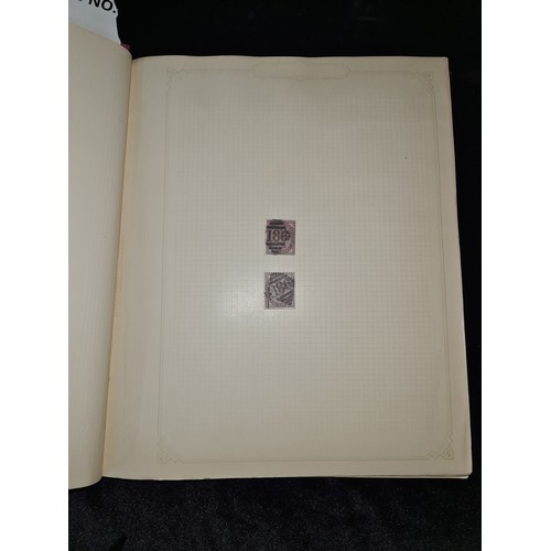 796 - Star Lot : Vintage red stamp album featuring a selection of early Irish Free State stamps. Including... 