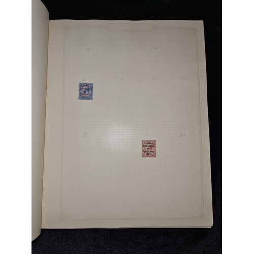 796 - Star Lot : Vintage red stamp album featuring a selection of early Irish Free State stamps. Including... 