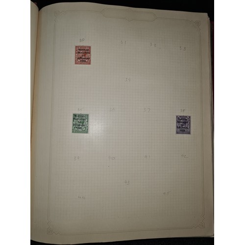 796 - Star Lot : Vintage red stamp album featuring a selection of early Irish Free State stamps. Including... 