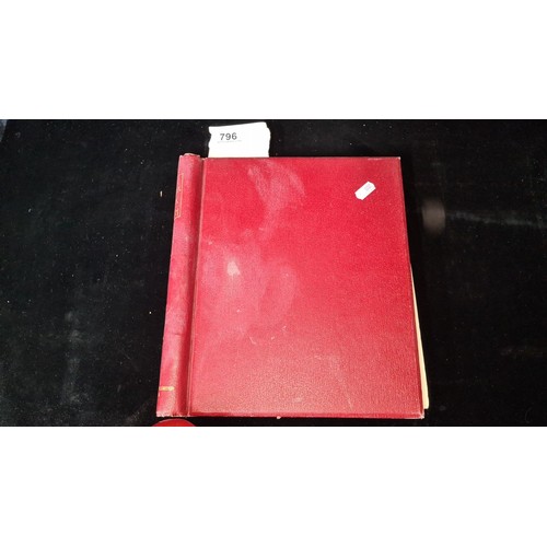 796 - Star Lot : Vintage red stamp album featuring a selection of early Irish Free State stamps. Including... 