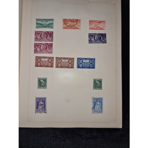 796 - Star Lot : Vintage red stamp album featuring a selection of early Irish Free State stamps. Including... 