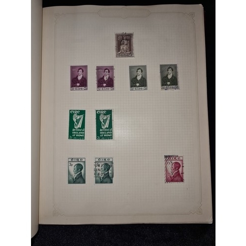 796 - Star Lot : Vintage red stamp album featuring a selection of early Irish Free State stamps. Including... 