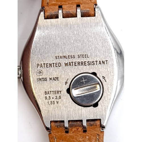 208 - A striking Swatch Swiss made gentleman's wrist watch with tan leather strap and stainless steel face... 