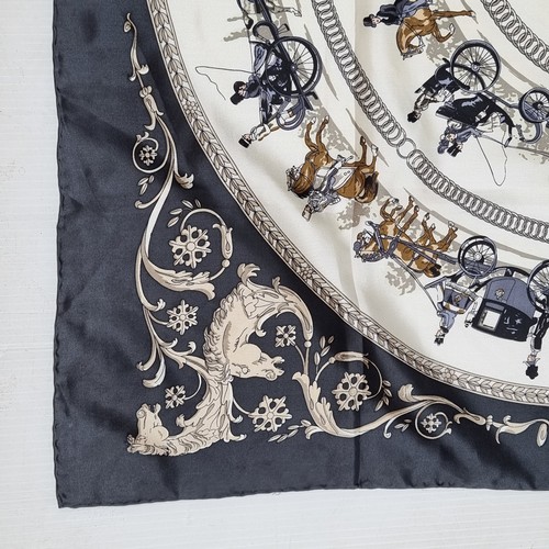 410 - An attractive LongChamps silk scarf with rolled stitched edging depicting La Promenade De Longchamps... 