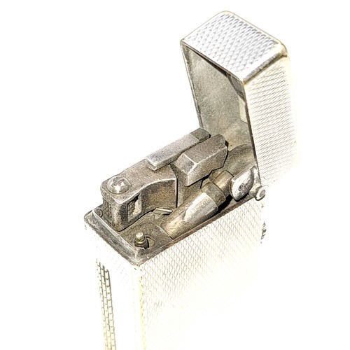 477 - A Super machine cut Dunhill flint lighter Made in Switzerland. . 7cm x 2cm. Weight 155.32g Retail on... 