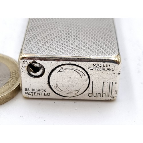 477 - A Super machine cut Dunhill flint lighter Made in Switzerland. . 7cm x 2cm. Weight 155.32g Retail on... 