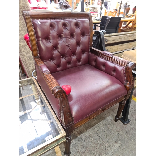 Star Lot : A handsome contemporary captains chair in a ox blood with button back detail.