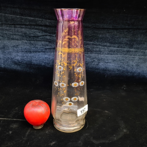157 - A very pretty tall vase with hand painted floral detailing and a ruby glass glaze. .