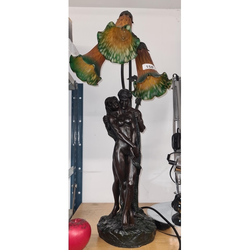 158 - A tall elaborate three tier lamp in the form of a nude male and female figure.