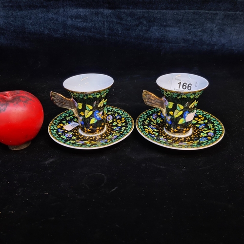166 - Star Lot : A pair of Versace by Rosenthal porcelain cup and saucers, model Gold Ivy, black and gold ... 