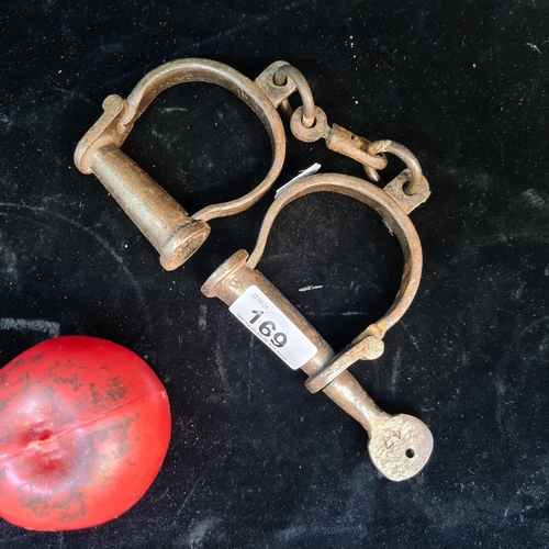169 - A brilliant pair of vintage figure eight hand cuffs with original key.