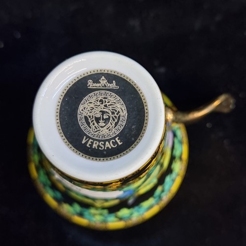 166 - Star Lot : A pair of Versace by Rosenthal porcelain cup and saucers, model Gold Ivy, black and gold ... 