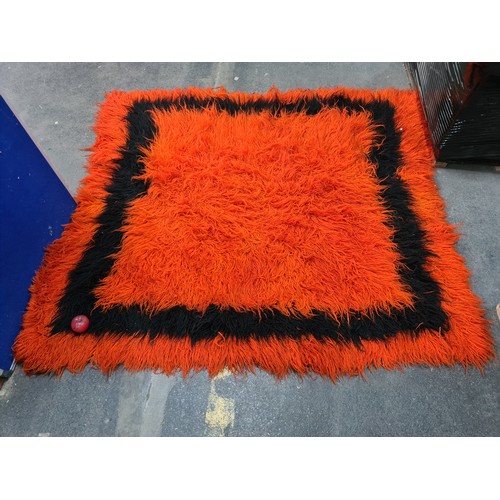 1006 - Star Lot : A spectacular mid century deep pile rug in a striking tangerine orange featuring a contra... 