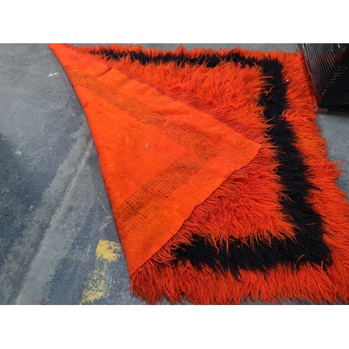 1006 - Star Lot : A spectacular mid century deep pile rug in a striking tangerine orange featuring a contra... 